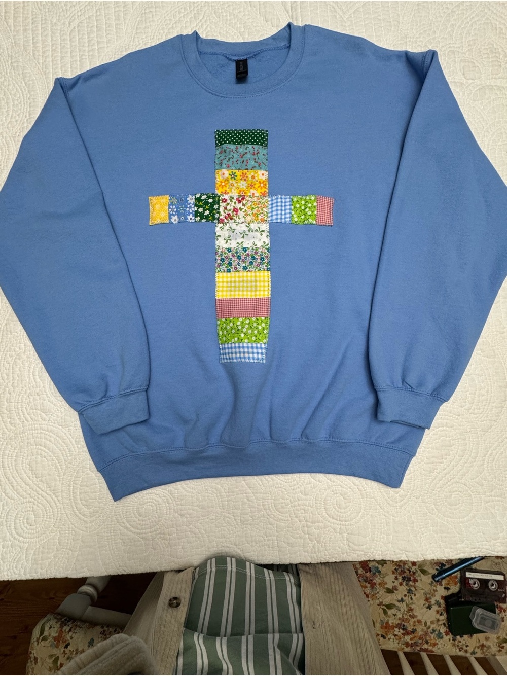 Boutique periwinkle blue sweatshirt with quilted patchwork cross
Size large
